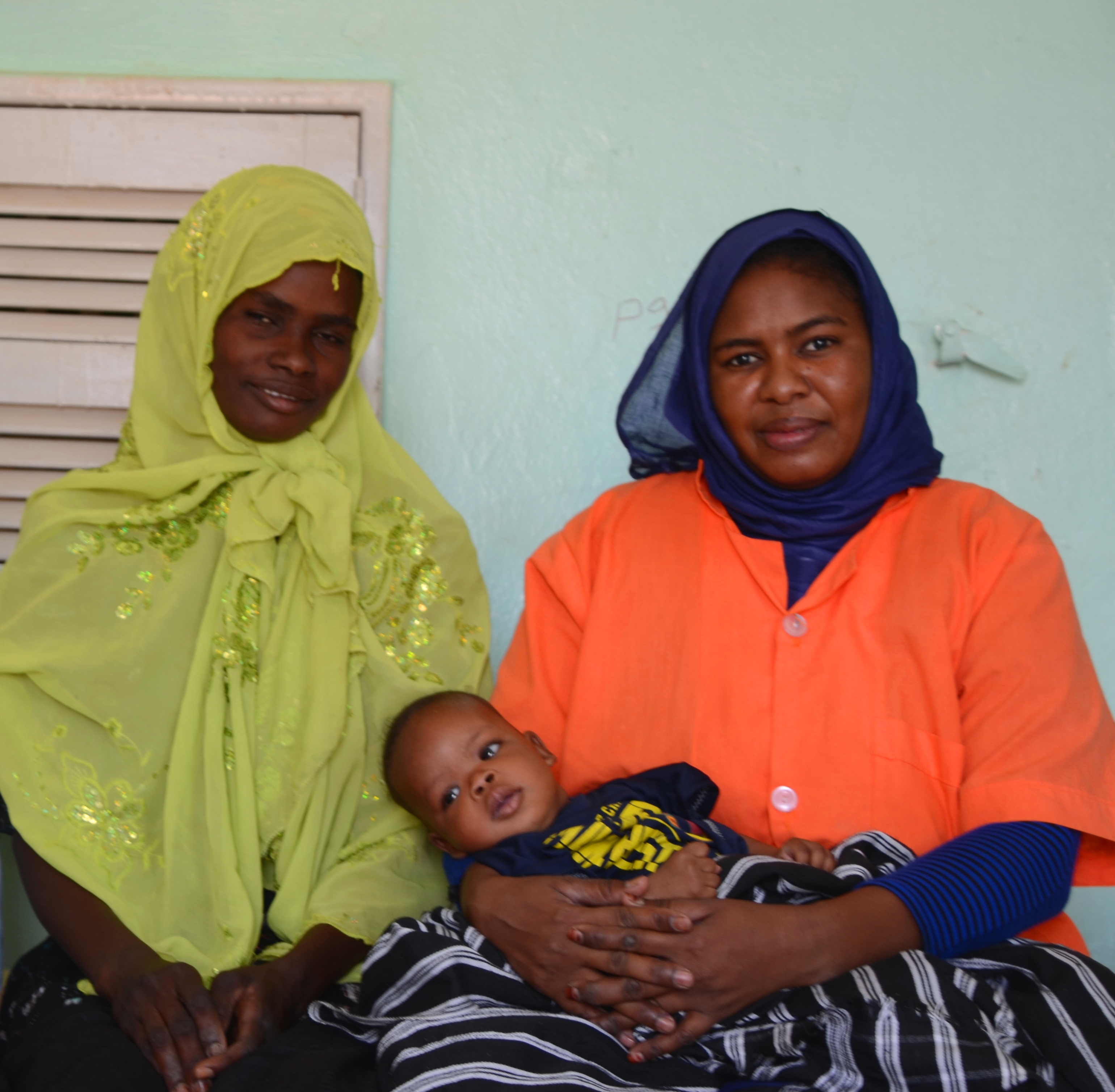 Mariem(in the left), sitting next to the Aminata, mother of baby Ibrahim, 2 months old , whom she helped giving birth