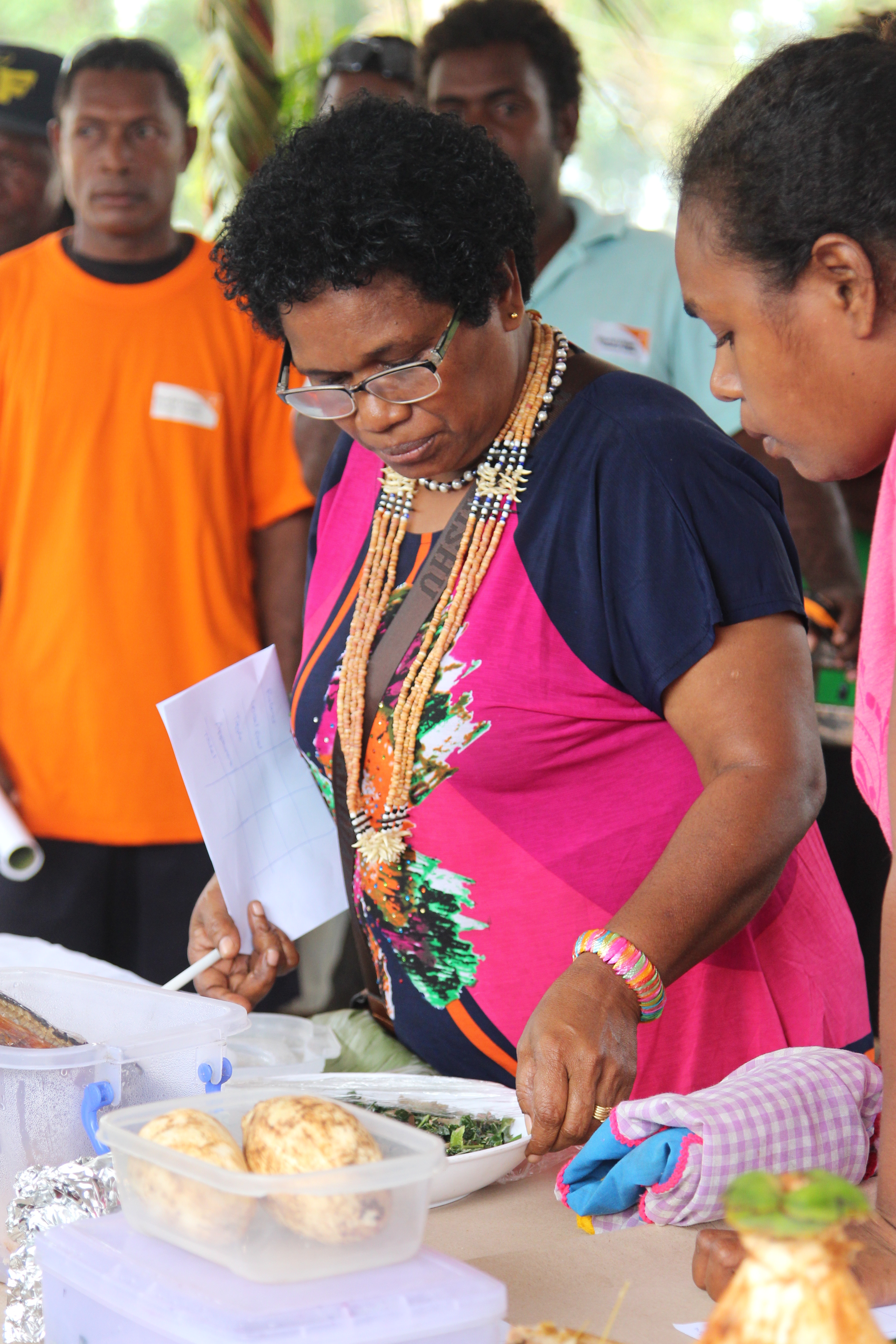 NCD National Coordinator, Nevalyn Leve, and Nutrition Officer, Arimer Hasi, inspect the meals brought to the cooking competition.