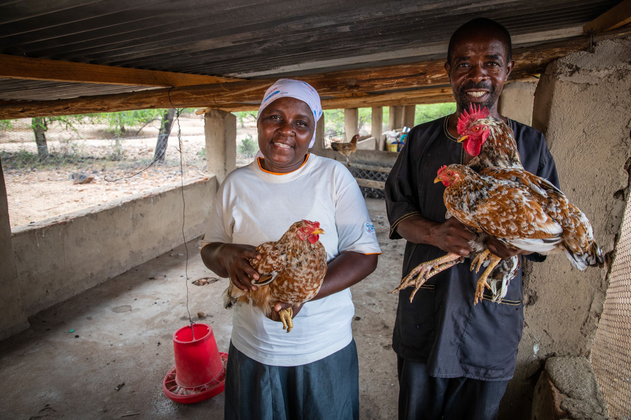 Women holding chickens