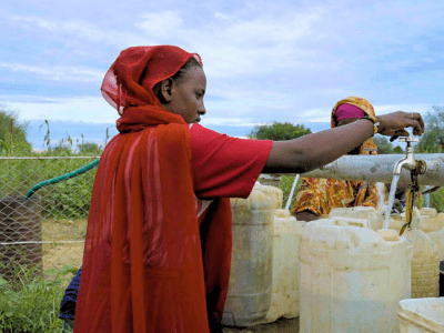 Samira fetching water at the Shamar water station in Blue Nile Sudan