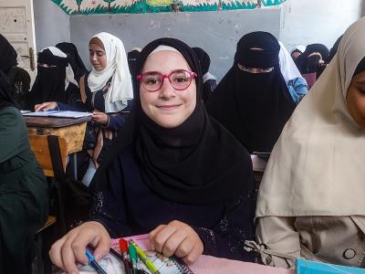 Lina* in her class with her new glasses