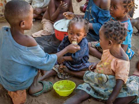 A baby is fed from her older brother in DRC
