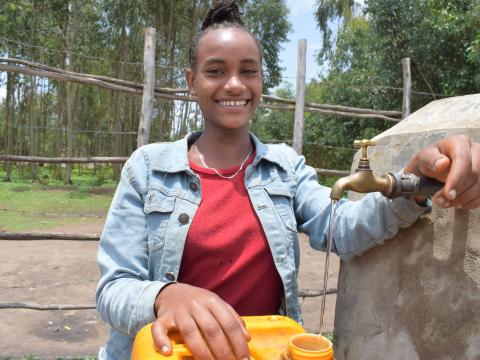 Bereket happy at her villages new potable water