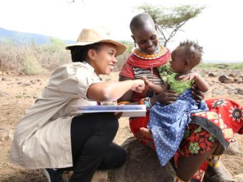 Everlin interacting with a mother and child in Marsabit, Kenya.
