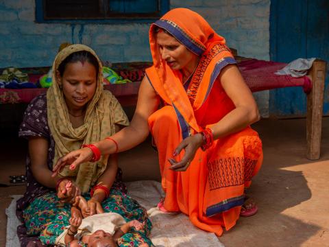 Community health worker helping mums in india