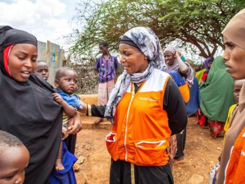 Mary Njeri, GHR director, meets with a mother and her children in Somalia