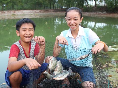 Children in Cambodia celebrate fish farming 