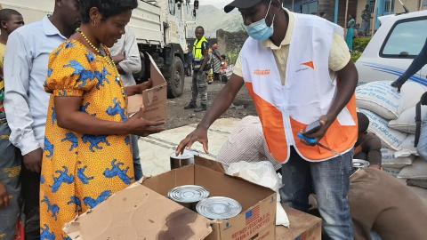 World Vision Staff member distributes food