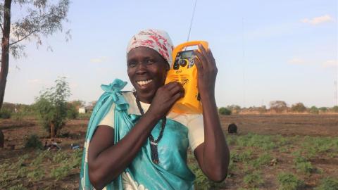 Woman listens to the radio in Africa