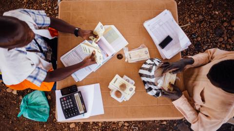 A trader returns food vouchers that have been redeemed for food in his store. Juba, South Sudan.