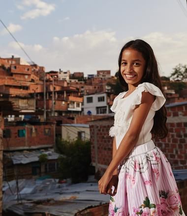 A Colombian girl stands in her village