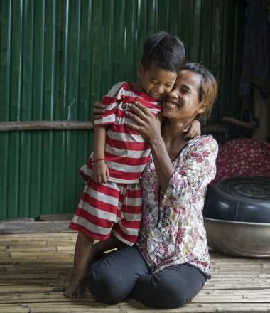 Khmer mother smiles and hugs her son