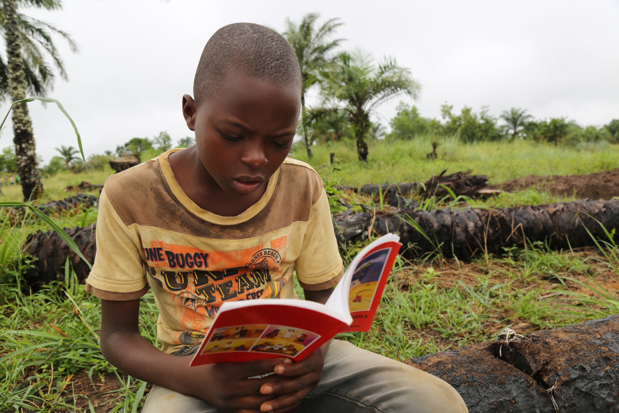 Ndibu, is a 13-year-old boy from Kasai, Democratic Republic of Congo, is reading a book. Ndibu wants to be an English teacher when he grows up.