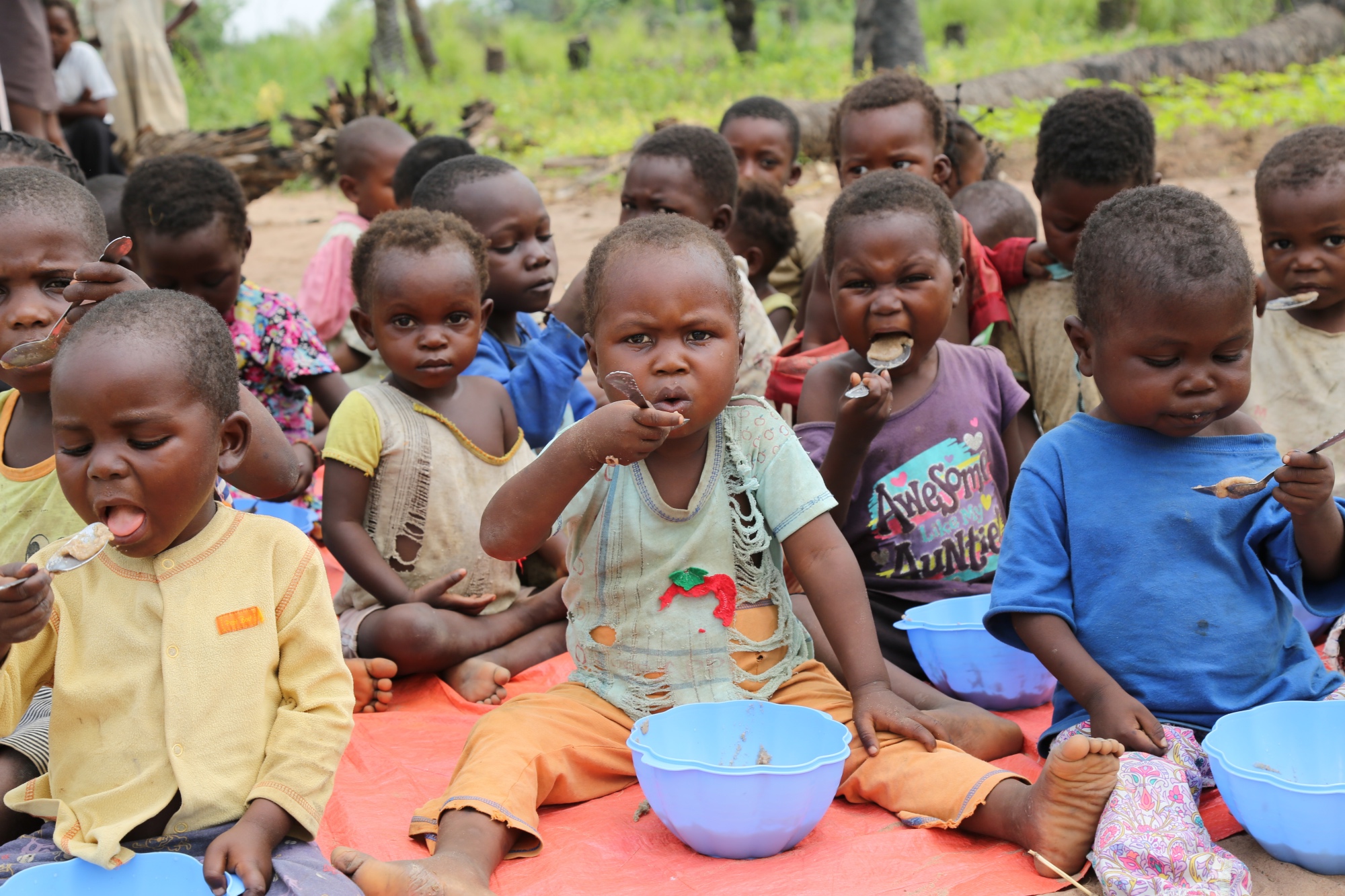 Children at a Child Friendly Space in Kasai eating porridge.  