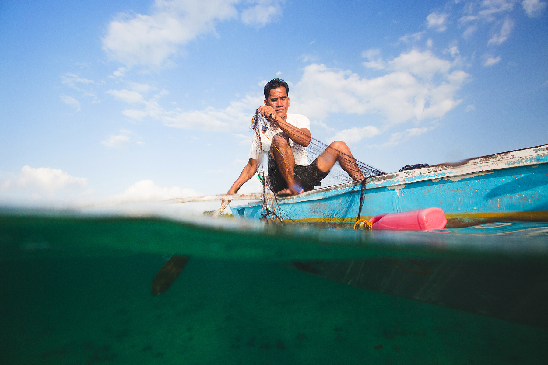 A fisherman in the Philippines uses a microloan to fund his small business