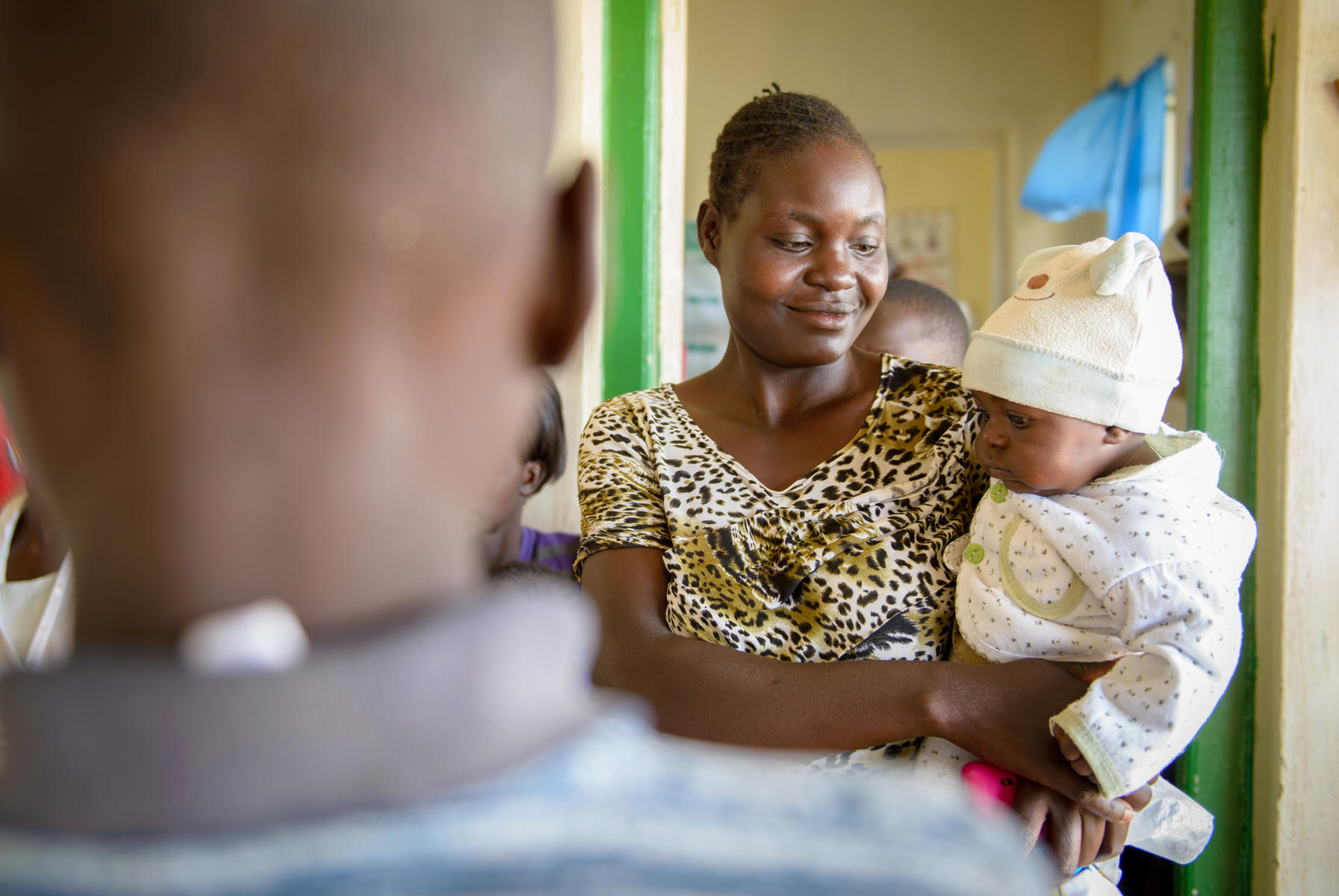 A mother holds her baby at a World Vision facility.
