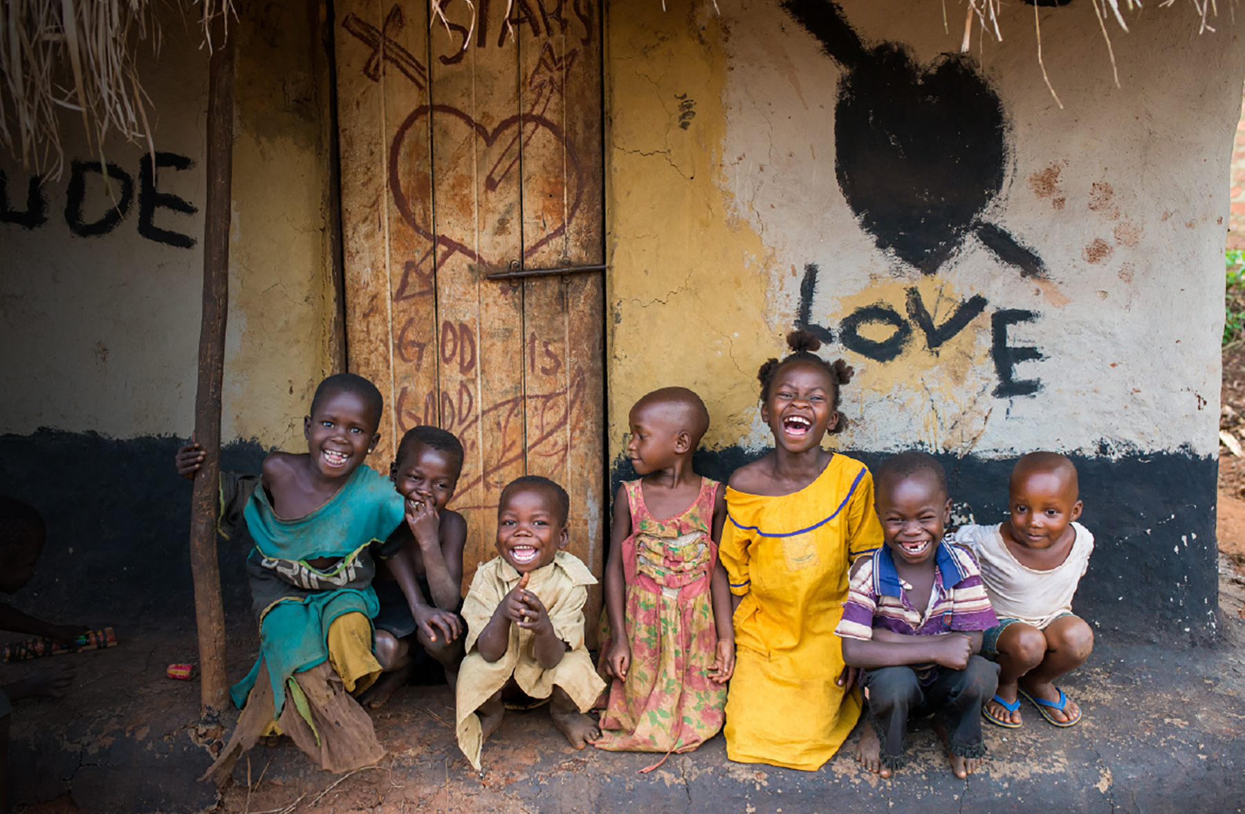 A group of children in front of a house