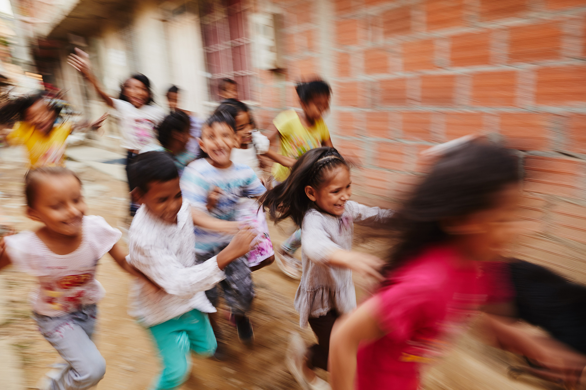 A group of children run in Colombia
