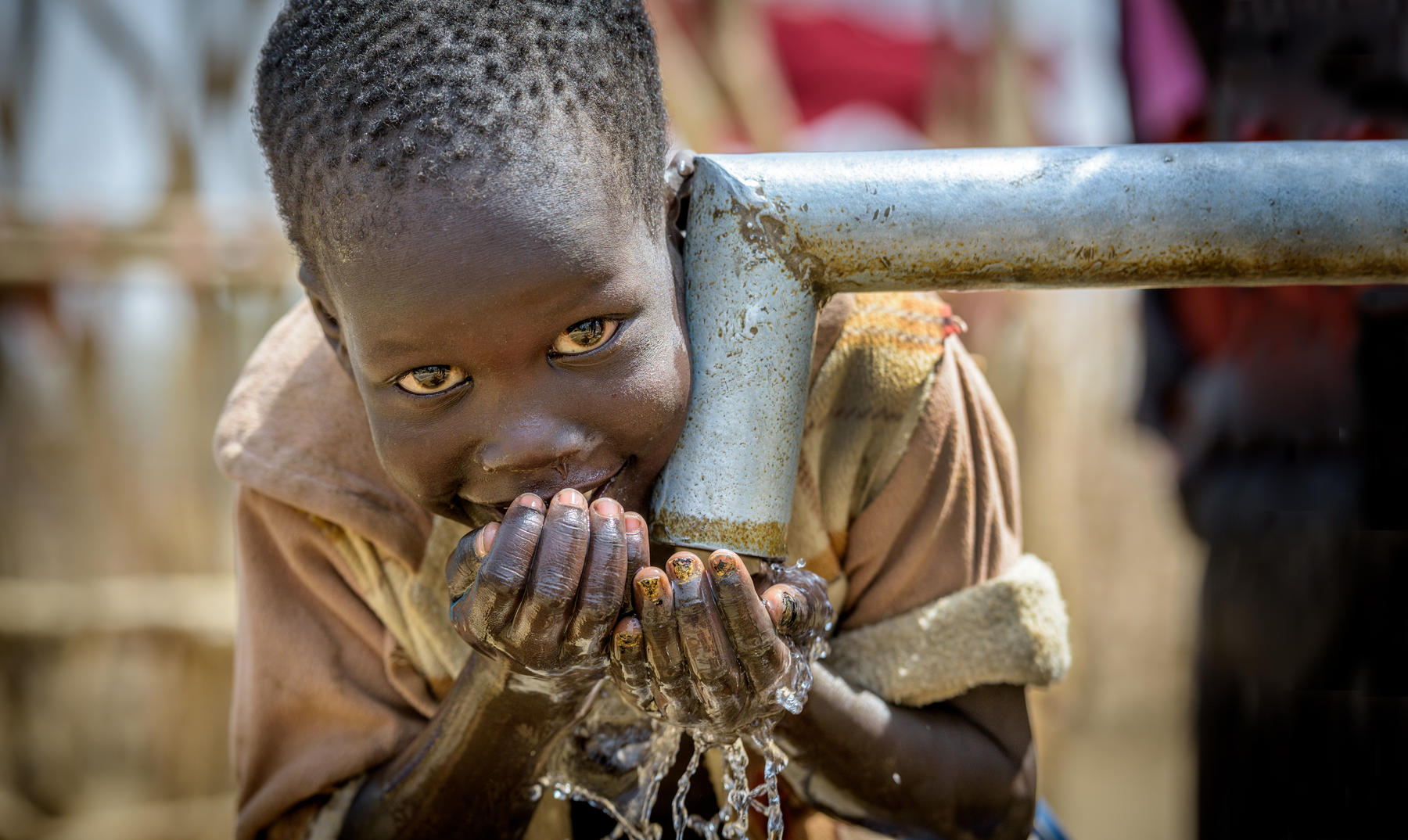 A boy in South Sudan drinks clean water