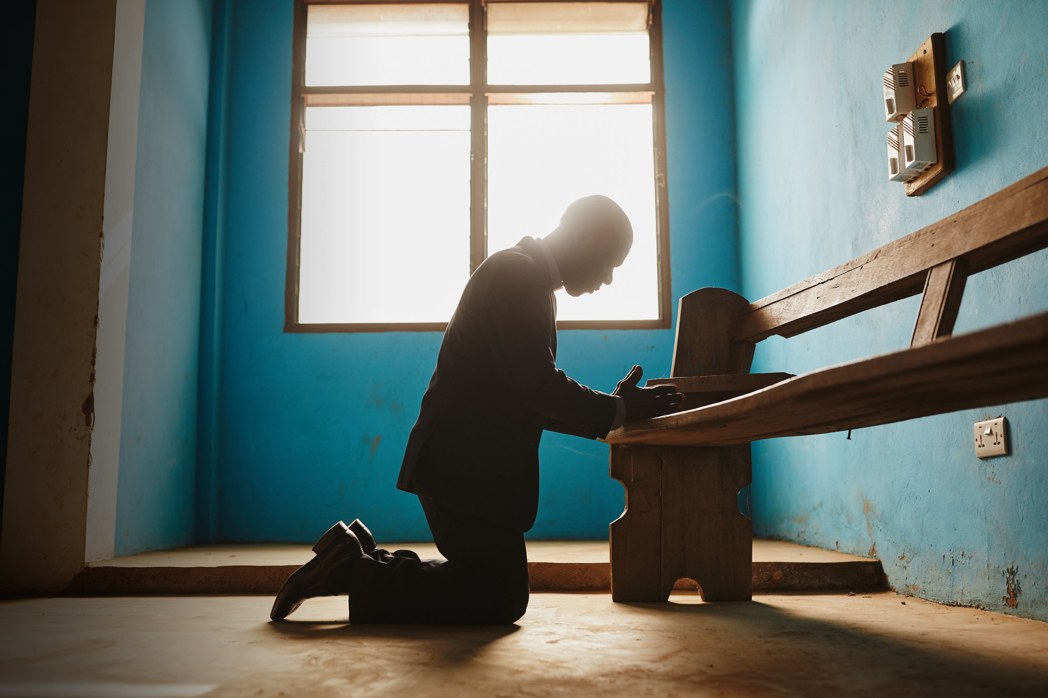 A Pastor on his knees praying
