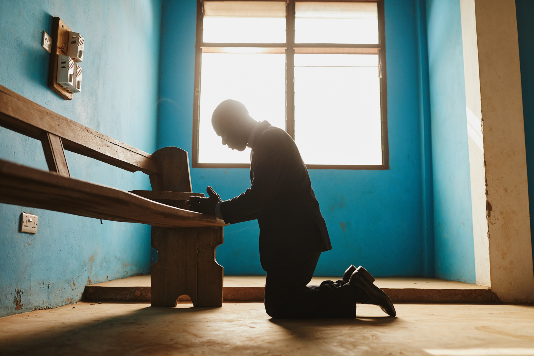 Man kneeling to pray in Ghana