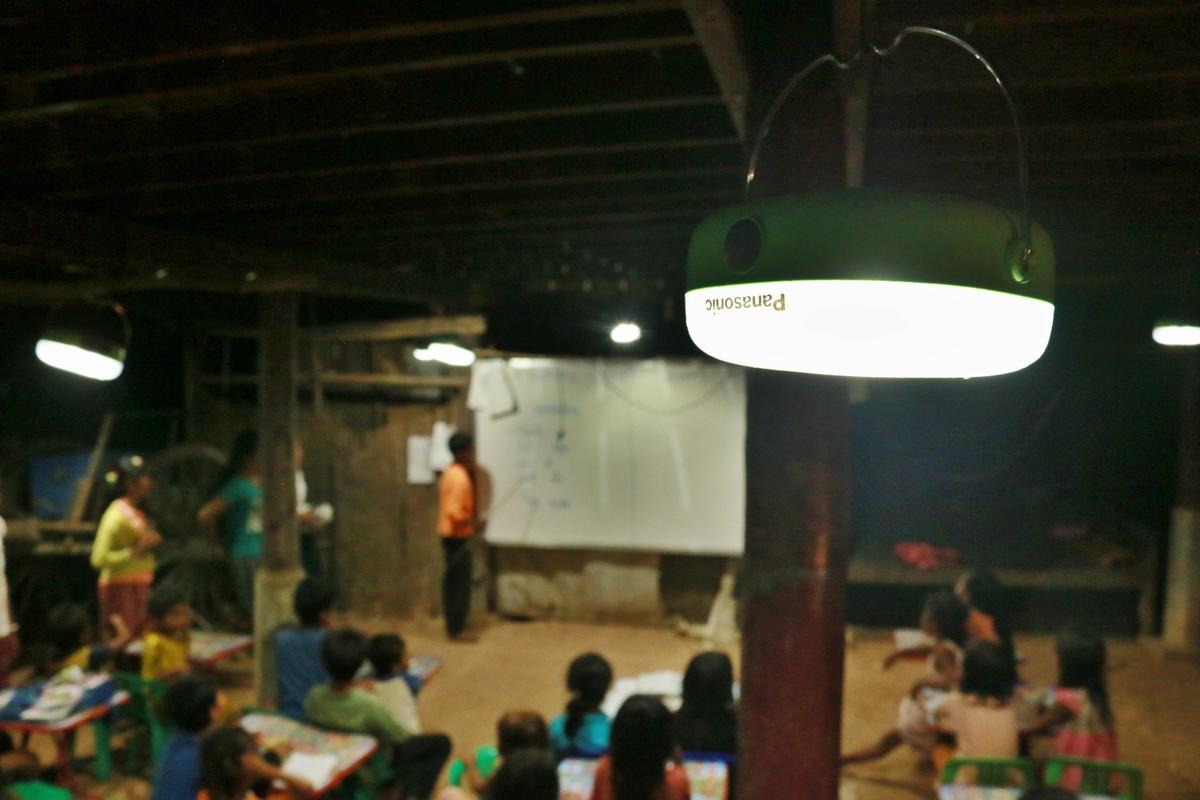 Panasonic lantern provides light for students to do their homework, Cambodia