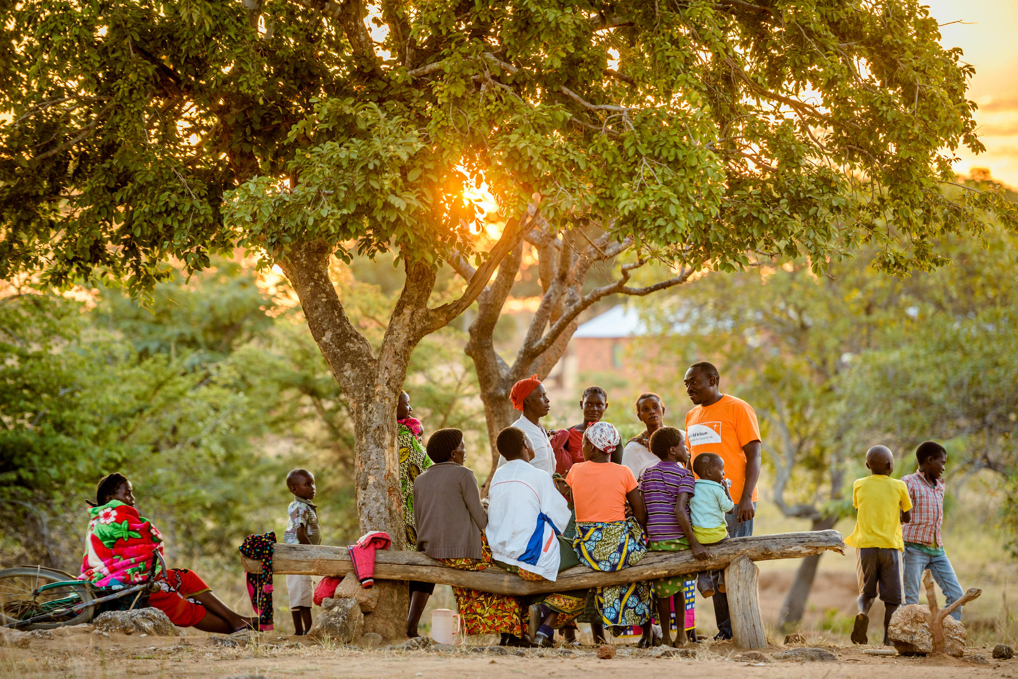 A World Vision staff member meets with the community