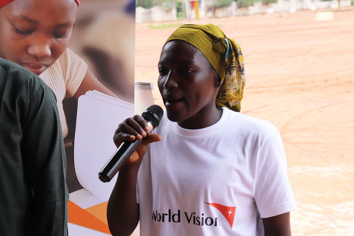 Woman speaking at microphone in Chad