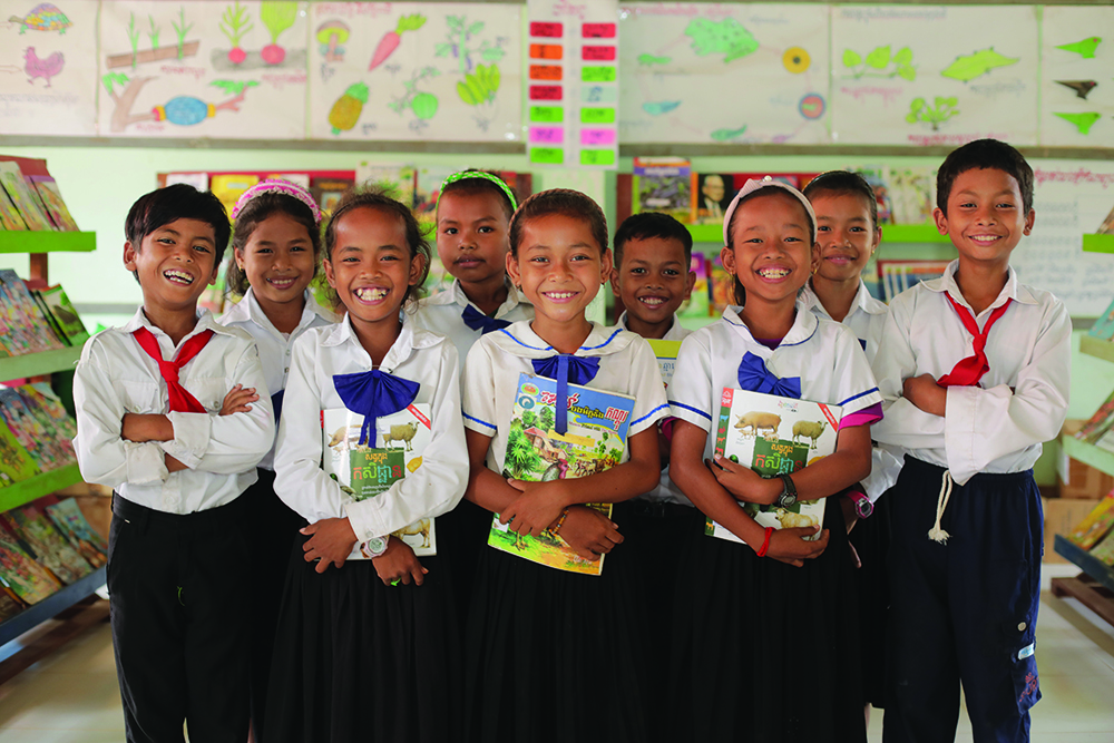 children standing in school with books