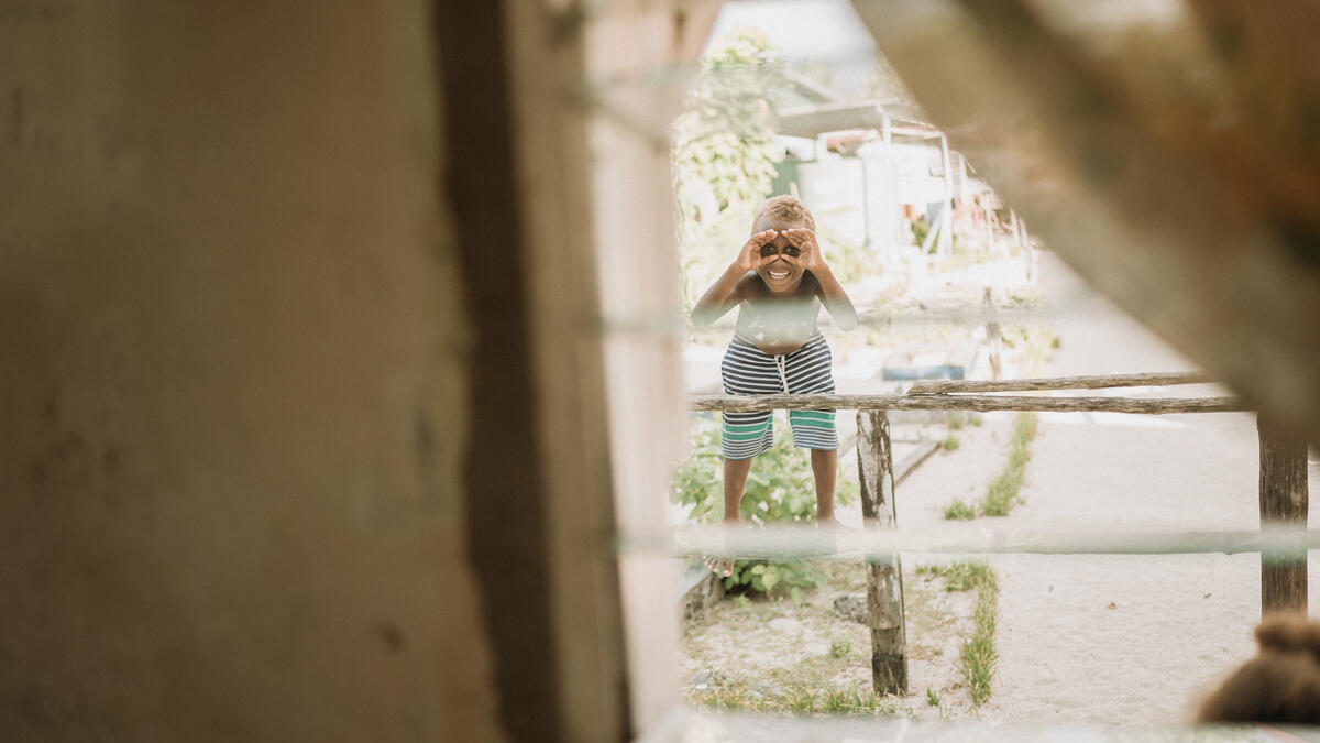 Child looking through window