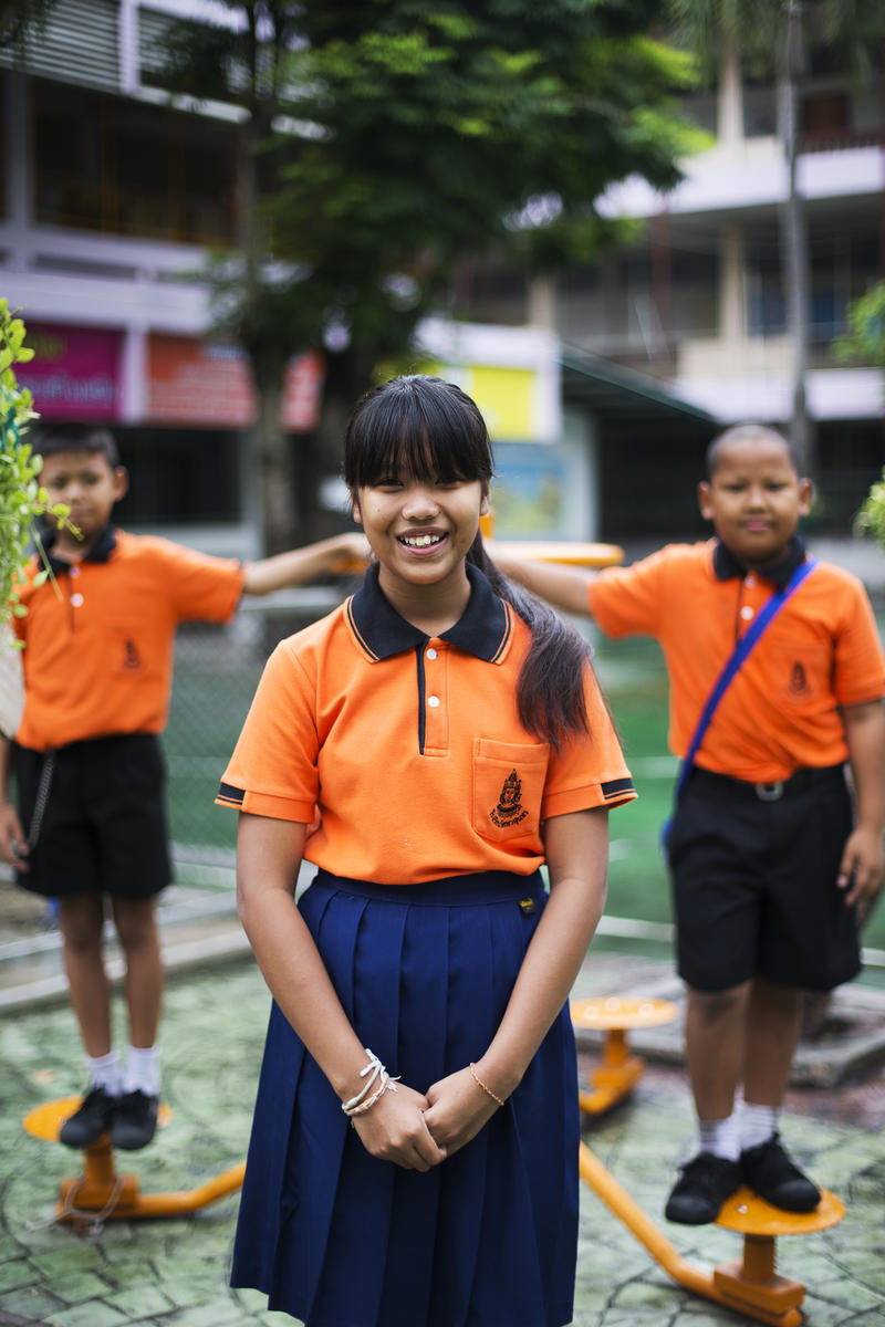 Girl from Thailand in orange shirt