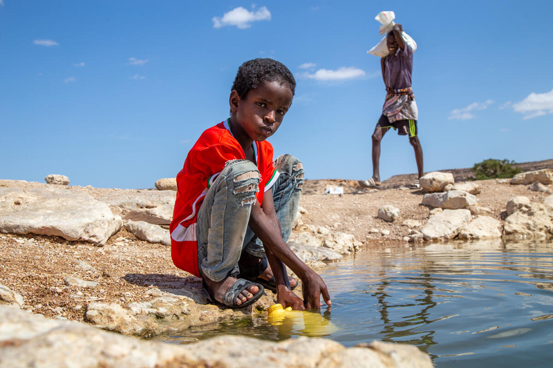 A ten-year-old boy withdraws water in Puntland, Somalia