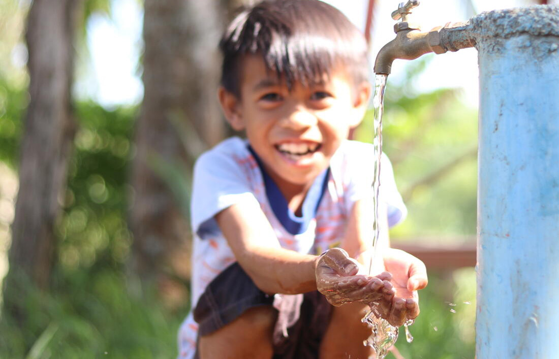 child washing his hands
