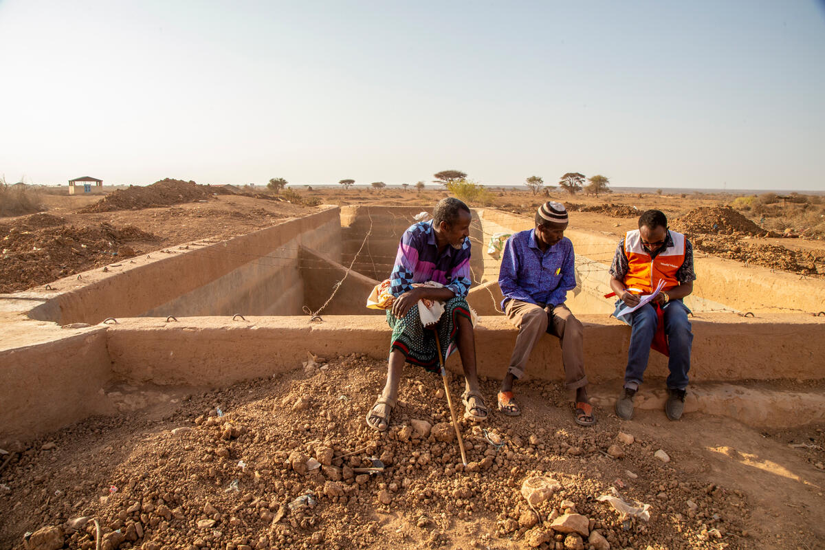 WVI staff speaks with villagers