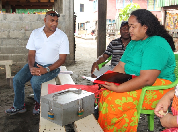 Sudila at the Lord Howe settlement talking with Margeret, record-keeper of the community's savings club established under World Vision programs