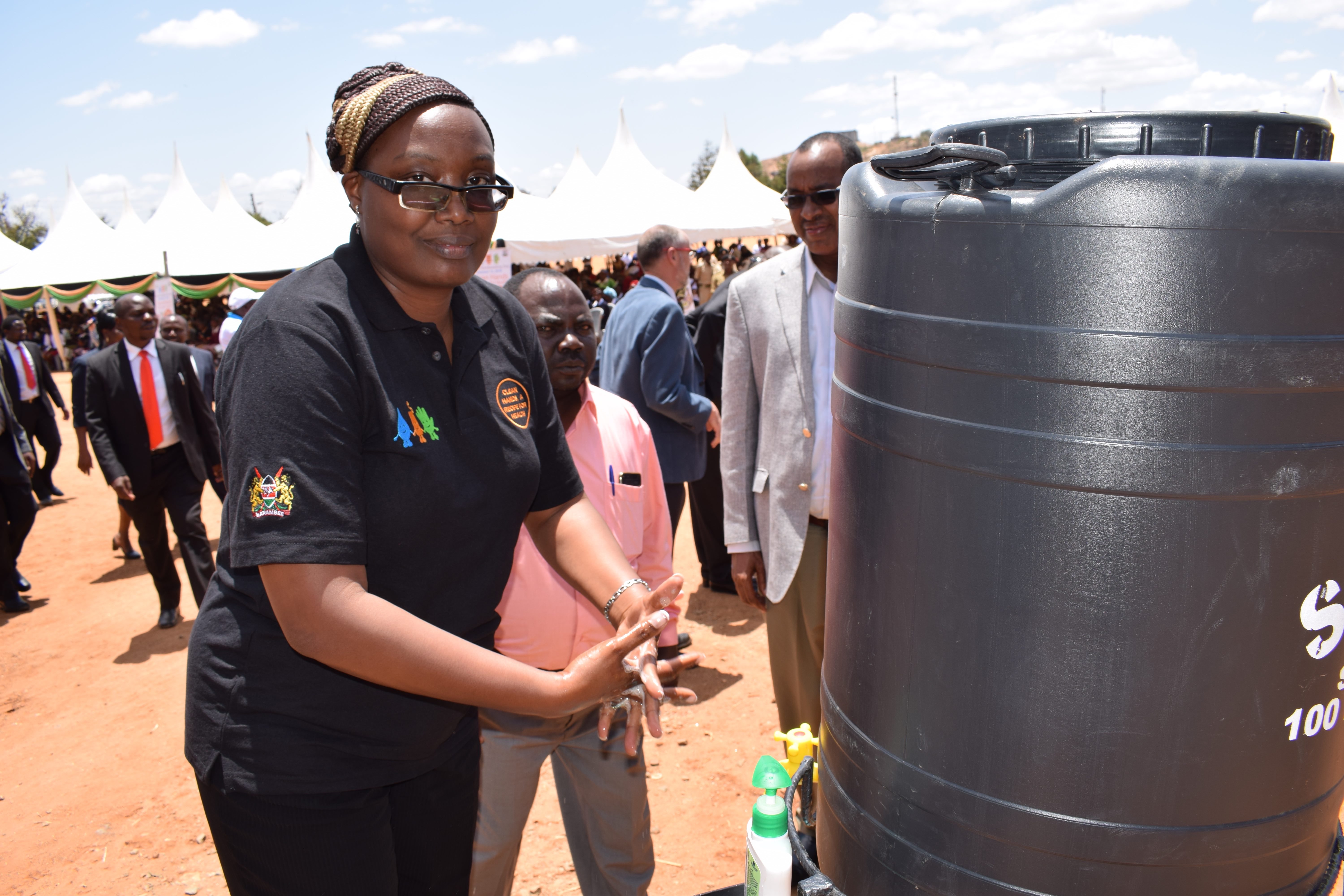 Wanjiku Kuria, a Technical Sanitation & Hygiene Specialist at World Vision Kenya demonstrating how to wash hands with soap and water during the 2018 Global Handwashing Day national celebrations held in Kitui County, Kenya. ©2018 World Vision/ Photo by Hel