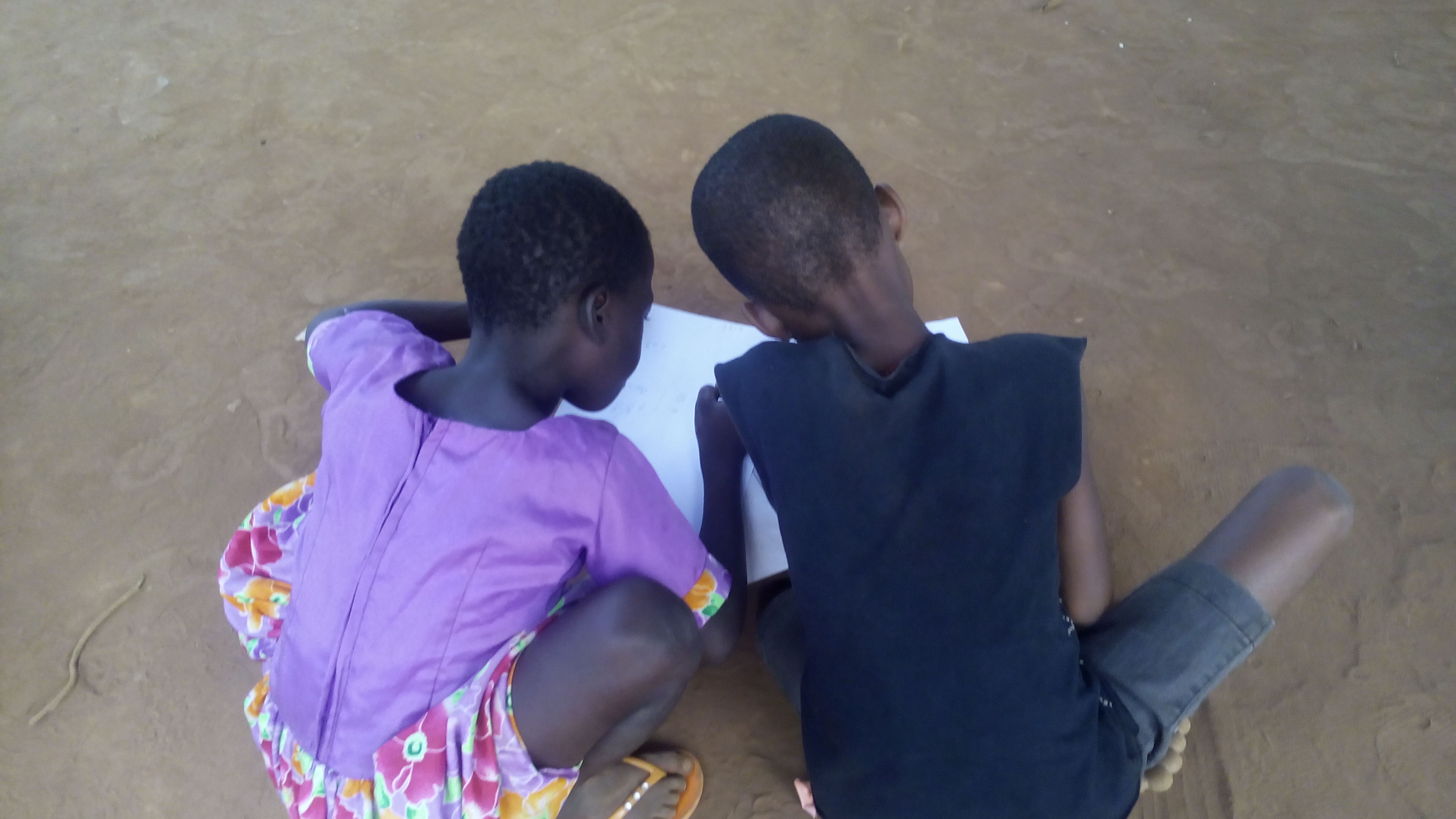 Children in Ghana read together at a Literacy Boost reading club
