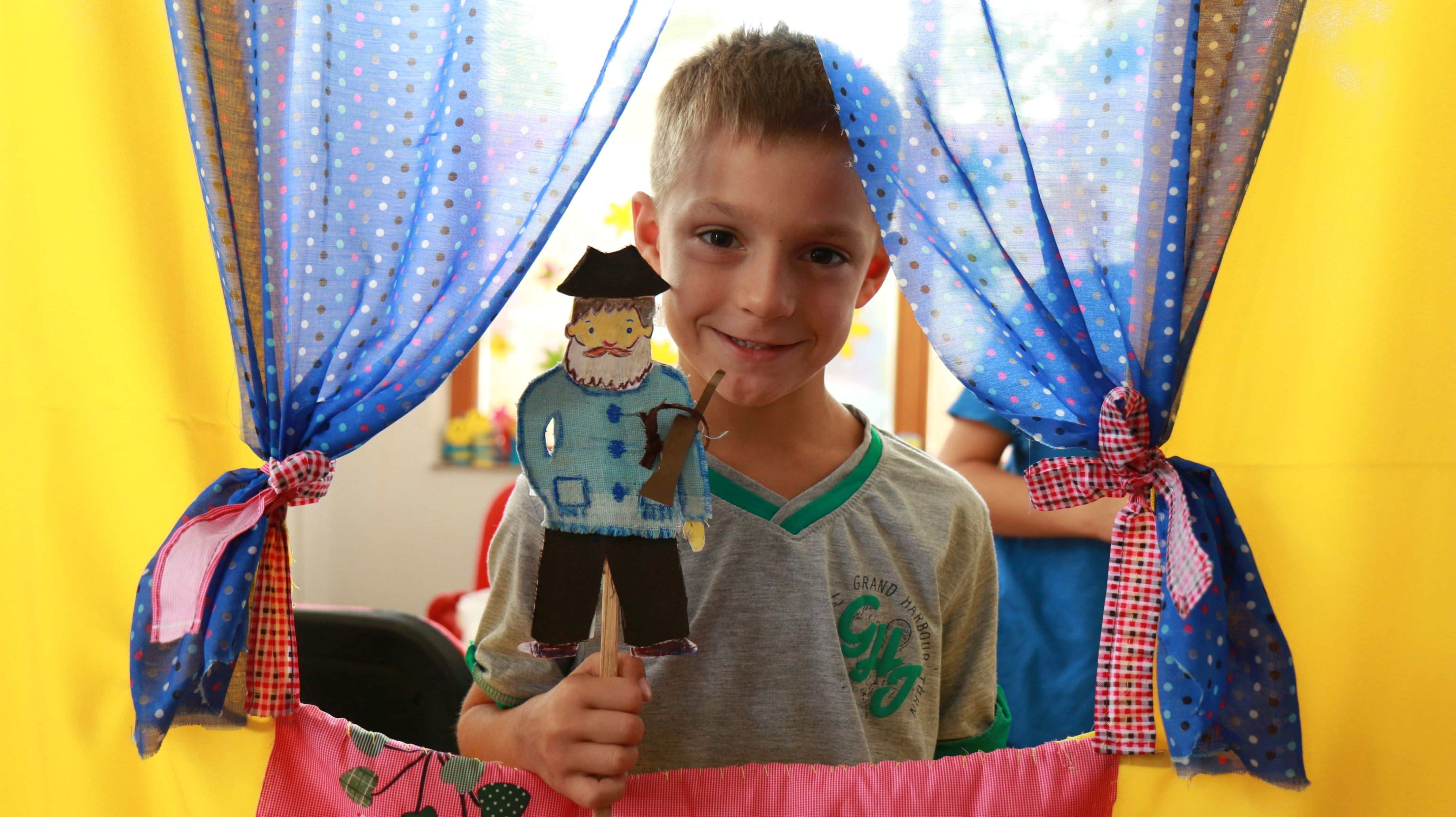 David is participating in a small-scale puppet show 