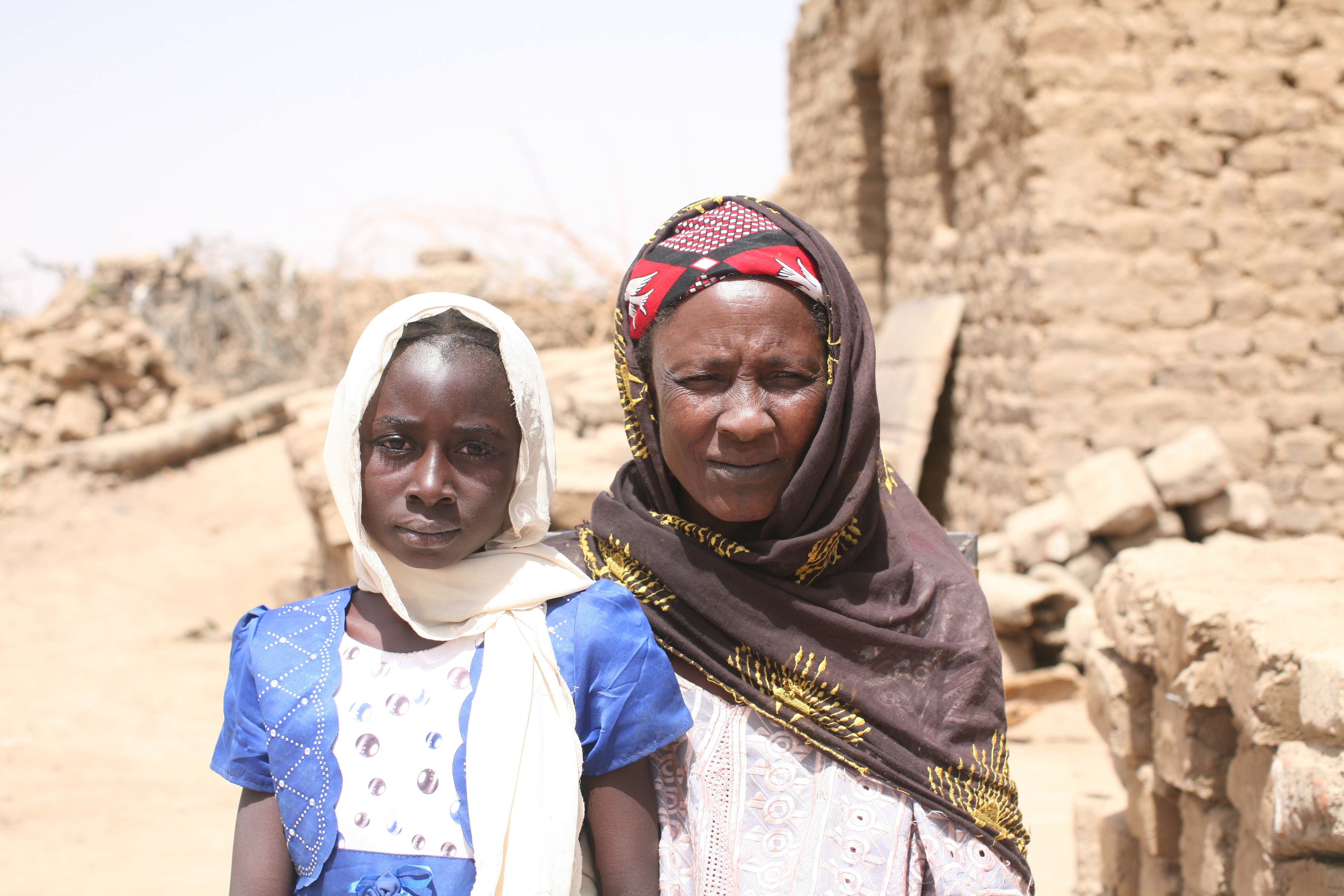 Nana with her grandmother in the compound of their home.