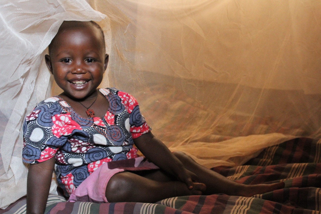 Girl under mosquito net