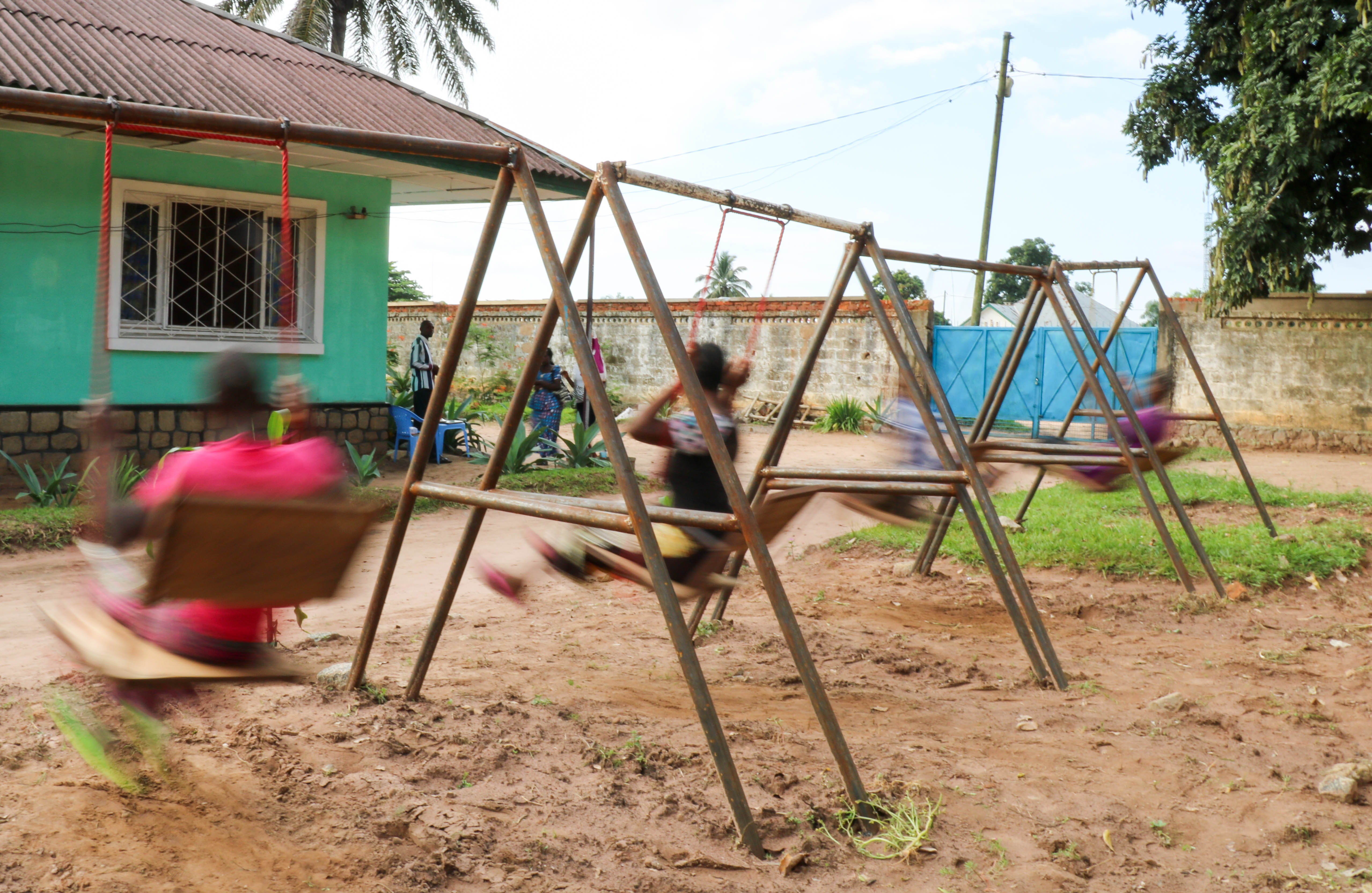 Four former militia members play on the swings at a centre for demobilised children in Kasai Central.  Forcibly recruited or eager militia member, physical or psychological injuries, all four of them are laughing and playing together. 