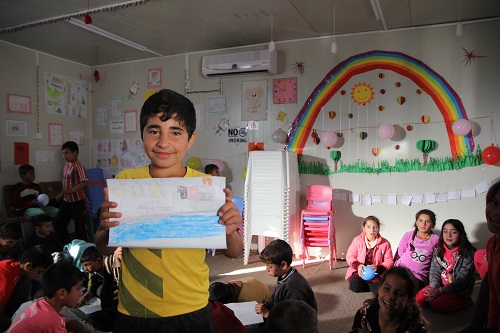 Child draws during Let Us Learn programme