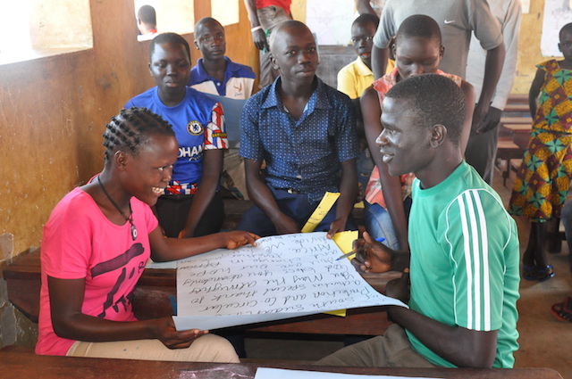 Peace club members discussing how to foster peace in their community