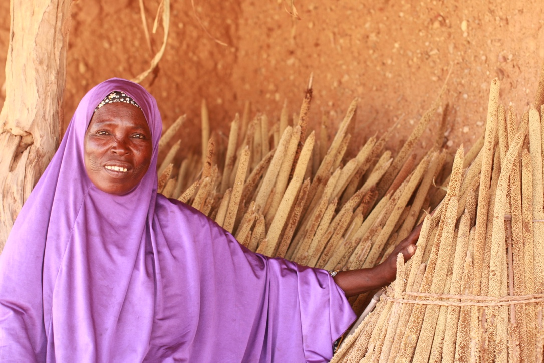 Tshara Yahaya (48) member of the village saving group showing her millet stock from this year harvest