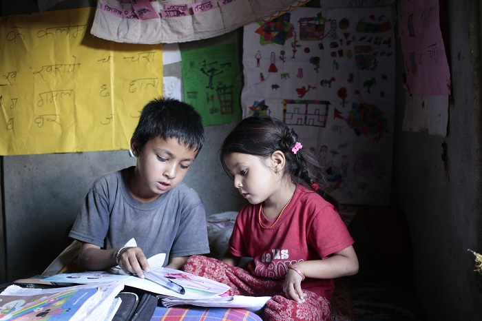 Jhalak studies with his sister at the reading corner at his home.