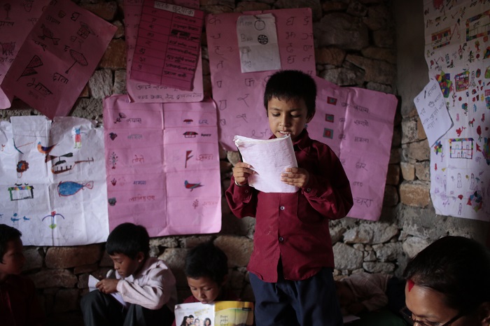 A child reads aloud at a literacy reading camp in Nepal