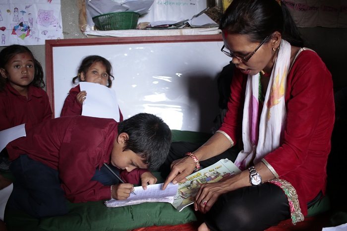 Reading camp facilitator reads to child