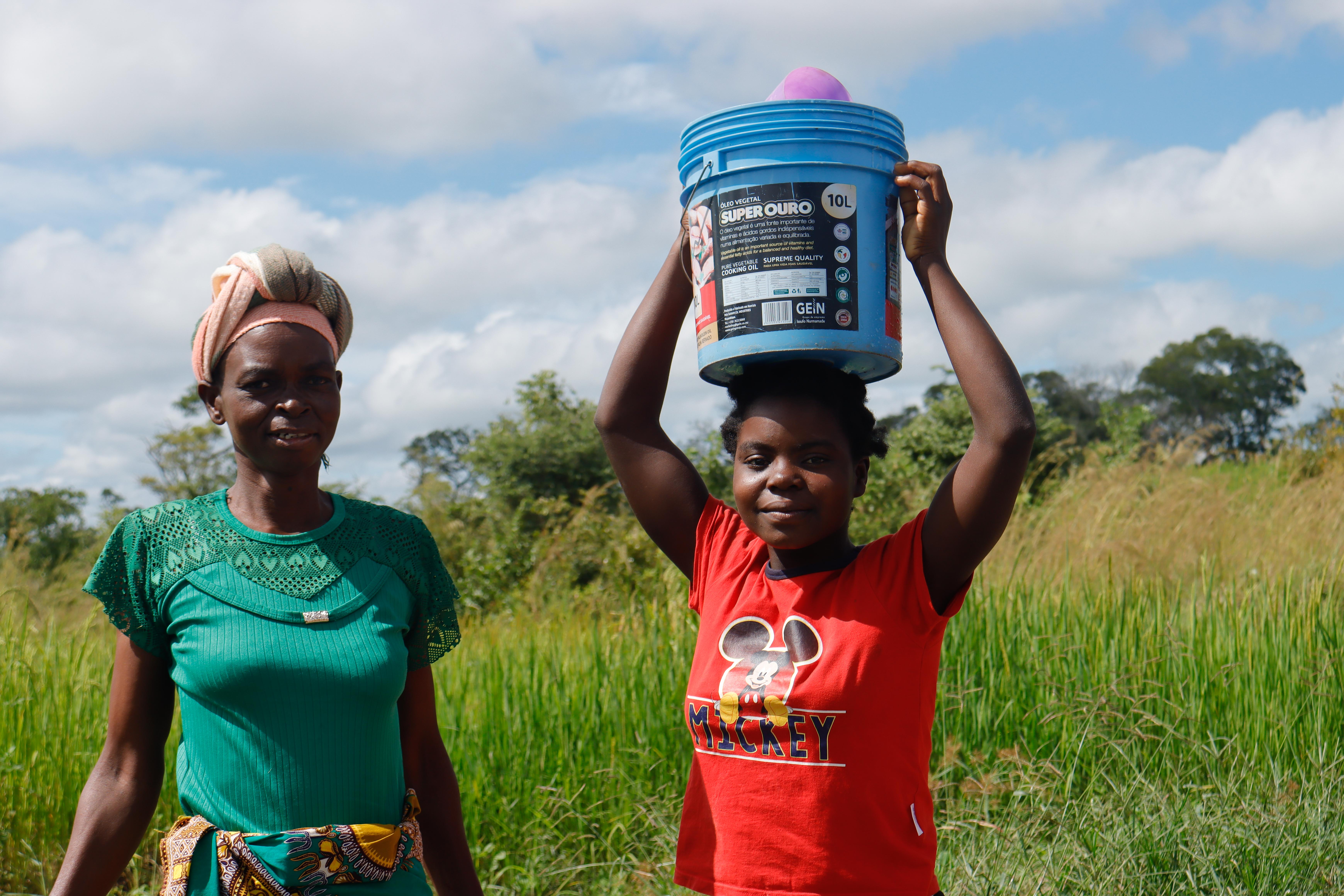 Helena experiences the joy of drinking clean water from the new borehole