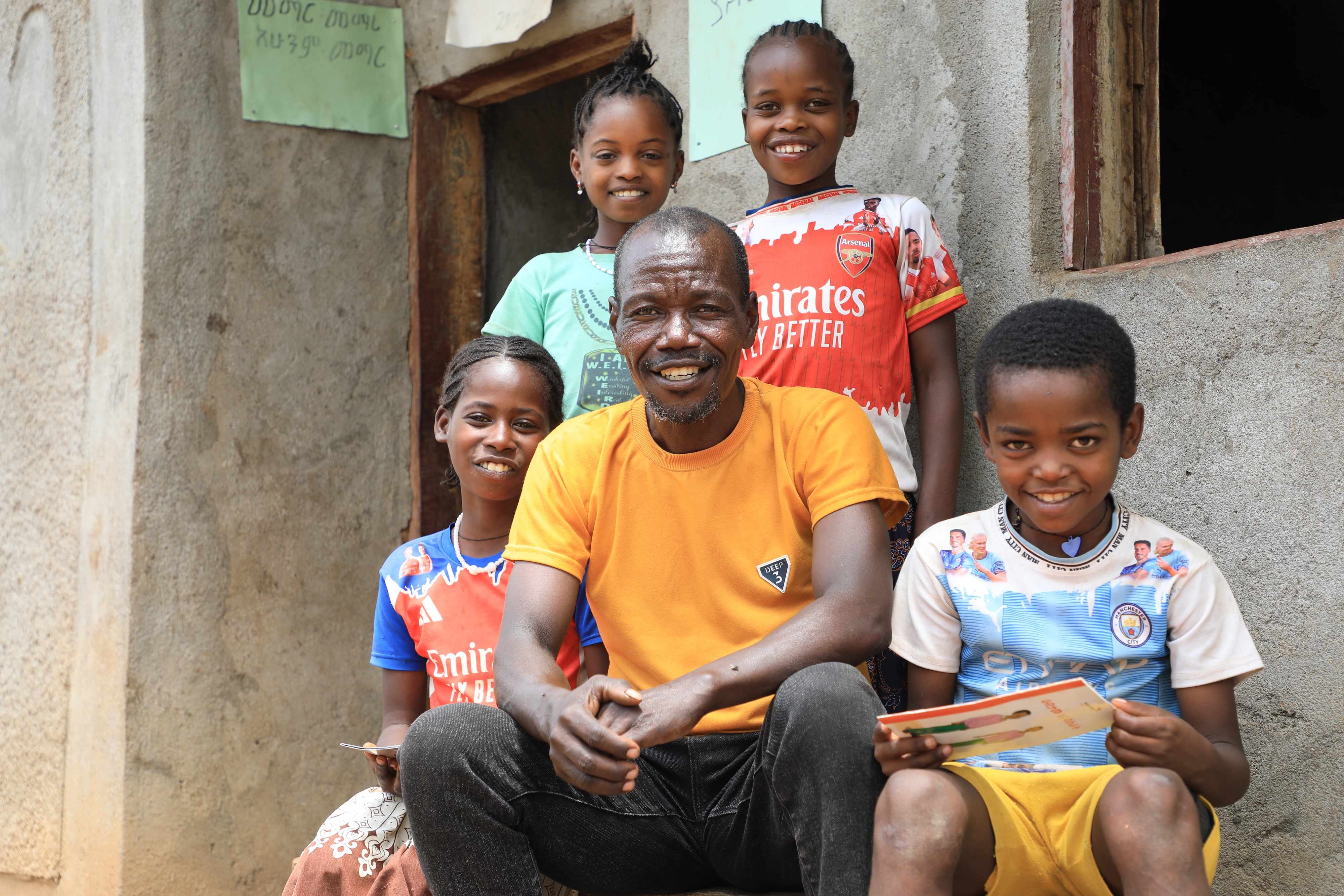 Kifle and with the children reading at his home
