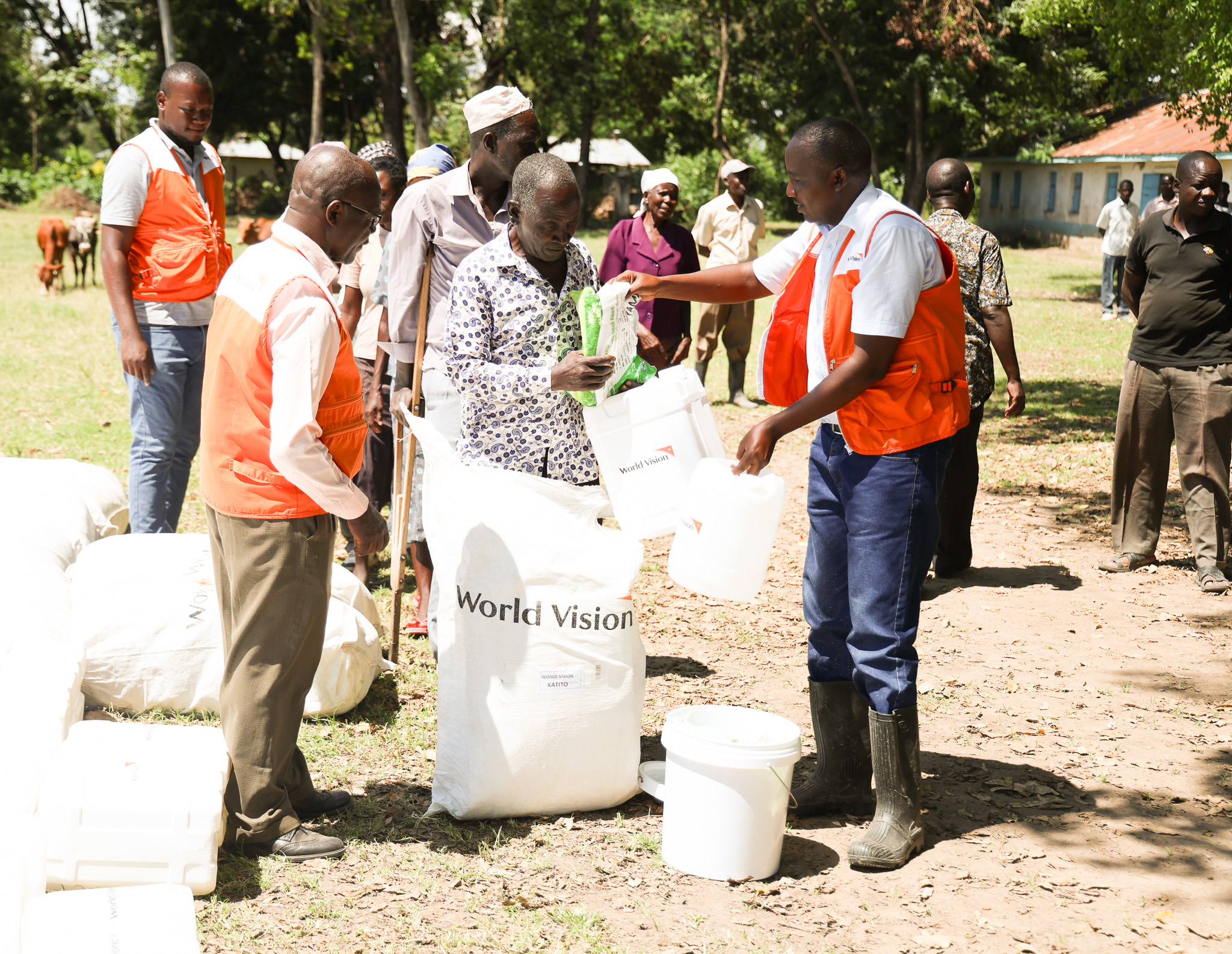 World Vision Kenya’s Migori, Homabay and Kisumu Cluster Manager Shadrack Yator(right) and World Vision’s Charles Komole Project officer, Sanitation and Hygiene (left) assisting in the distribution of Non-Food Items kits (NFIs) to the registered 30 most needy flood-affected families in Kobuya Village in Rachuonyo Sub-County